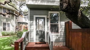 A house with a front porch, a wooden staircase, and a mailbox. - Downtown oasis, walking distance to Capitol, UT, Zilker Park, music venues (Austin)