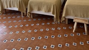 A hotel room with three beds, each with a woven headboard and a beige blanket. There is a woven hanging light fixture above the beds. - Family Villa in LISBON,heated pool,elevator,parking,6 bedrooms,sleeps 14 (Lisboa)