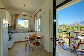 Enjoy meals in the dining area with a table and chairs, and take in the scenic views from the adjacent balcony.