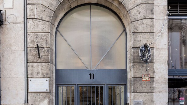 A stone building with a large arched entrance, numbered 10, and a plaque indicating it is the residence of Dr. Balogh Károly. - Grandiose 3BR § 3BathR apt, middle of downtown. Back and better than ever! (Budapest)