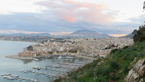 A coastal cityscape with a harbor, historic buildings, and a mountainous backdrop. - villa with views over Scopello (Scopello)