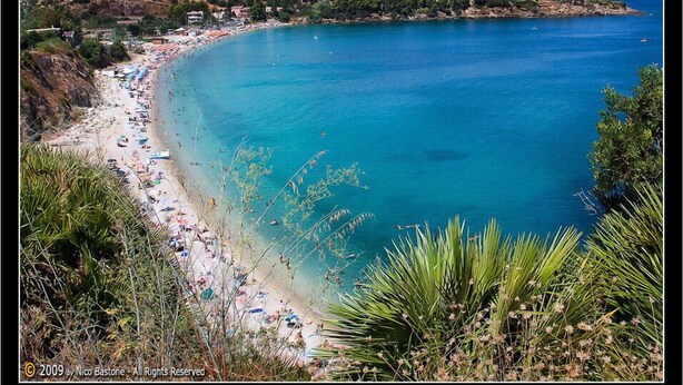 A coastal beach with clear blue waters, sandy shore, and surrounding vegetation. - villa with views over Scopello (Scopello)