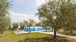 A park with a blue building, trees, and a white structure. - TABACHERA x10 Country House Sirmione GARDA LAKE (pozzolengo)