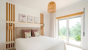 A bedroom with a large bed, a bedside table, a hanging light fixture, and a window with a view of greenery. - Casa EmCanto - Swimming pool, games room, cinema with capacity for 16 guests (Pombal)
