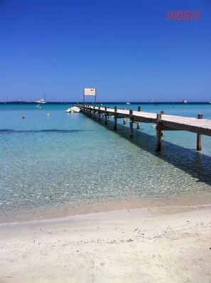 A pier extending into clear turquoise waters with a sign reading "Ribbit Dock". - Superb ground garden villa, close to beaches, santa giulia, WiFi, air conditioning (Porto-Vecchio)