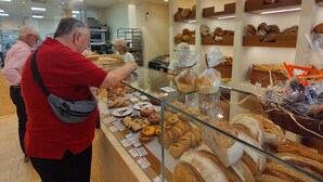 A bakery display with various baked goods and a person taking a photo. - Fast-E WiFi/On-St parking/Metro Hub @290m/Cafe Society Enclave. (Valencia)