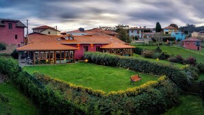 A residential area with houses, a well-maintained lawn, and a bench. - THE ERA OF SOMAO (Somado)