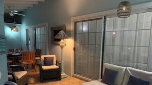 Ein Wohnzimmer mit Sofa, Stühlen, einem Esstisch und einer Lampe.