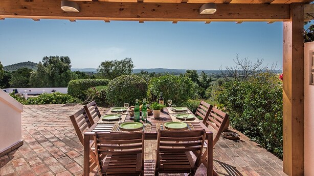 An outdoor wooden pergola with a table set for dining, overlooking a landscaped garden and distant hills. - Villa Susana ~ Heated Pool* ~ Fast Wi-fi ~ 6 + 4 cots - Booking 2027 & 2028 NOW! (Sao Bartolomeu de Messines)