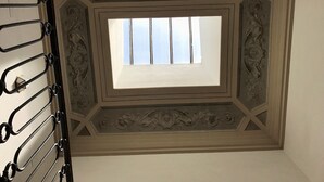 A room with a skylight, decorative ceiling, and a metal rack. - Characteristic Apartment in the City Center of Florence (Firenze)