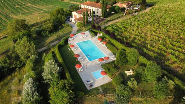 An aerial view of a villa with a swimming pool surrounded by lush greenery and vineyard fields. - Buon Riposo - Farmhouse in the heart of  Tuscany, two bedrooms house - free wifi (MONTAIONE)