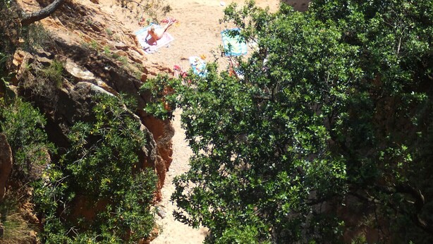 A coastal beach with clear water, rocky outcrops, and lush greenery. - Except Nice. Duplex overlooking S'agaro Bay (S'agaro)