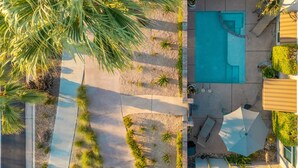 An aerial view of a resort with a swimming pool, palm trees, and a patio area. - Beautiful & Romantic Downtown Private Pool & Spa.  Amazing Westerly facing views (Palm Springs)