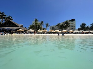 On the beach, sun loungers, beach towels - Oceanfront Modern Penthouse in Playa Norte text us 317-652-1366  (Isla Mujeres)