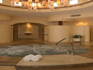 A spa area with a hot tub, a wall-mounted sink, and a potted plant. - Oceanfront, BradAndJoeyRentals -Fully Remodeled, stocked, steps to beach.  (Nuevo Vallarta)