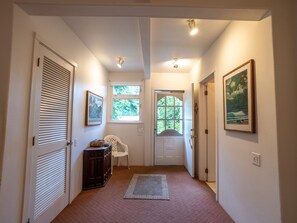 Entrance from private porch/lanai with table, chairs, Grill for outside Dining.