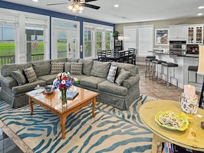A living room with a sofa, coffee table, and a rug.