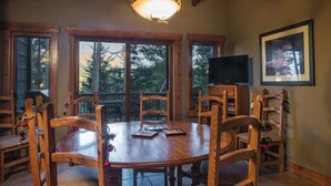 A wooden dining table with chairs, a television, and a framed picture on the wall. - SmallGroup-SmallRate! Great Layout/Views/HotTub/PoolTable/Grills/Ski In Ski Out! (Breckenridge)