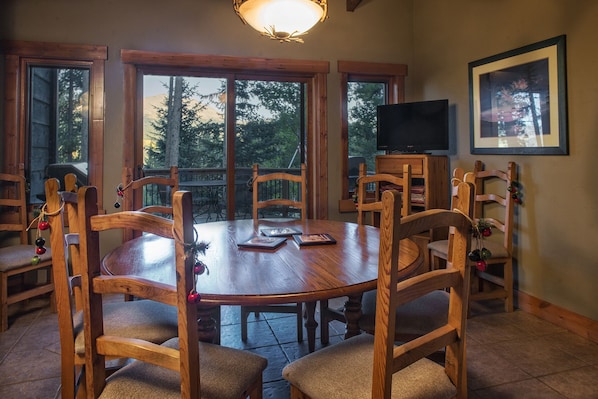 A wooden dining table with chairs, a television, and a framed picture on the wall. - SmallGroup-SmallRate! Great Layout/Views/HotTub/PoolTable/Grills/Ski In Ski Out! (Breckenridge)