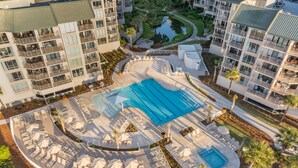 An aerial view of a resort with a large swimming pool, sun loungers, and a landscaped garden. - Spacious Oceanfront Condo in Palmetto Dunes, Unobstructed Ocean Views  (Hilton Head Island)
