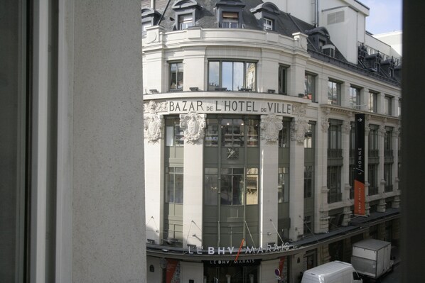 A building with a sign reading 'Bazar de l'Hotel de Ville' and 'Le BHV Marais' indicating a hotel and a location.