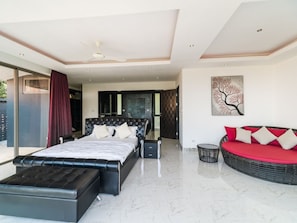 A modern bedroom with a large bed, a sofa, and a dining area. - 3 Bedroom Sea View Villa 2 - Chaweng Noi SDV162-By Samui Dream Villas (Koh Samui)