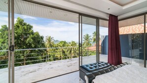 A modern bedroom with a large sliding glass door leading to a balcony with a view of palm trees and a distant mountain. - 3 Bedroom Sea View Villa 2 - Chaweng Noi SDV162-By Samui Dream Villas (Koh Samui)