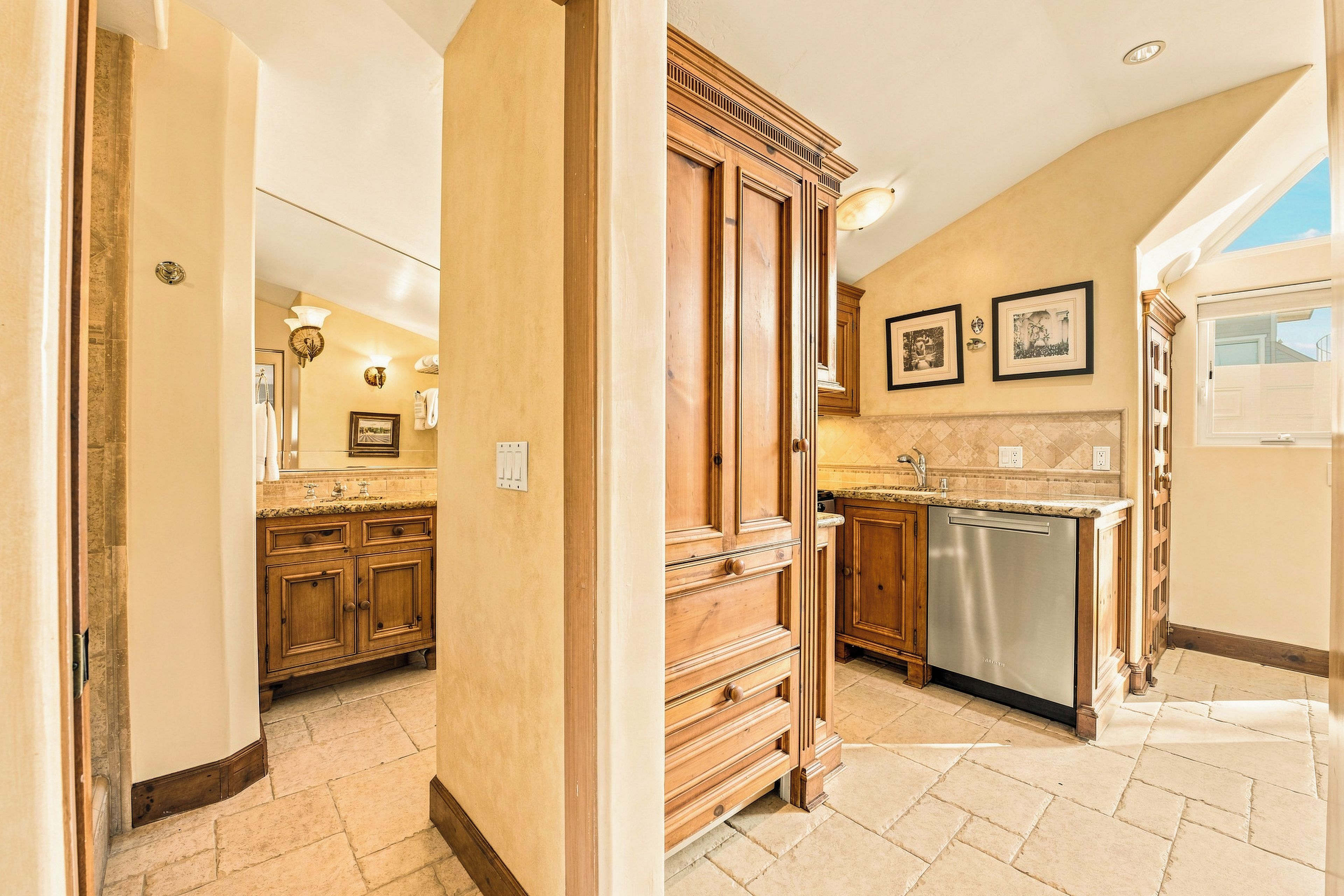 A kitchen with wooden cabinets, a dishwasher, and a tiled backsplash.