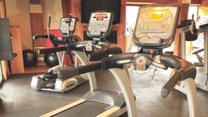 A gym with treadmills and exercise equipment.