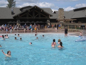 Relax by the large pool surrounded by a covered seating area with a traditional design.