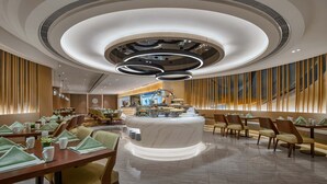 A modern dining area with a central island, multiple seating arrangements, and a distinctive ceiling design.