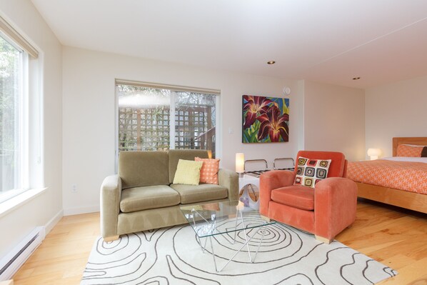 A modern living room with a sofa, armchair, and a glass coffee table. - Victoria, ~BC~ - Fully Furnished-Self Contained Garden Suite (Victoria)