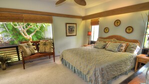 A bedroom with a bed, a bench, a nightstand, and a potted plant. - PRIVATE HOME: 5 Min Walk to Beach, Pool & Tennis Courts (Koloa)