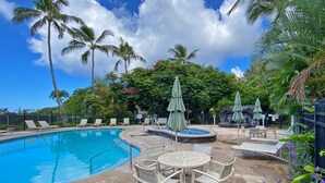A swimming pool with lounge chairs and umbrellas, surrounded by palm trees and greenery. - PRIVATE HOME: 5 Min Walk to Beach, Pool & Tennis Courts (Koloa)