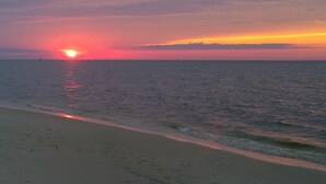 A beach at sunset with calm waters and a distant horizon. - A Short Walk to Dauphin Island Beach.*Pets Welcome* 
special rates 20% Discount  (Dauphin Island)