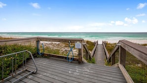 A wooden boardwalk leading to a beach with a sign instructing to place shoes on the rack. - Beach Resort 215 Beach Setup included* HUGE value added.  Perfect Pool View. Convenient Access (Miramar Beach)