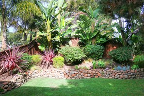 Escape to a serene oasis surrounded by lush tropical foliage and a tranquil garden setting.