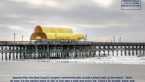 A pier with a yellow canopy labeled "APACHE PIER" and a sign for "OCEAN REFRESHMENTS."