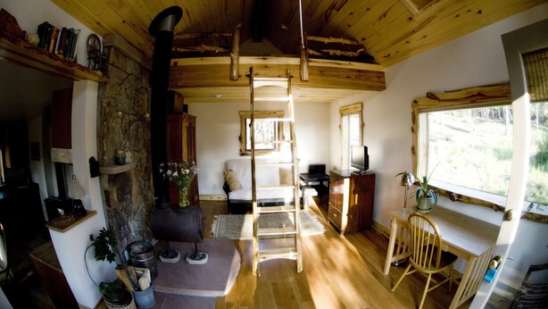 A rustic cabin interior with a loft bed, wooden ceiling, and a desk area with a chair. - Mountain View Chalet - Fantastic Views and Privacy  (Blackhawk)