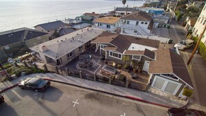 A residential area with houses, a street, and a view of the ocean. - Beautiful Ocean View! Steps to Sand! Private Home with 3 Car Driveway! (Laguna Beach)