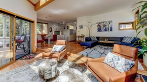 A spacious living room with leather sofas, a coffee table, and a large window. - Pearl st, A/C, Fireplace, Views and Decks- Winner (Boulder)