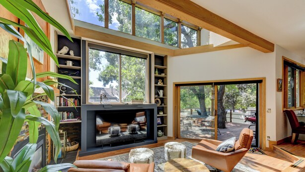 A spacious living room with a fireplace, comfortable seating, and large windows offering a view of the outdoors. - Pearl st, A/C, Fireplace, Views and Decks- Winner (Boulder)
