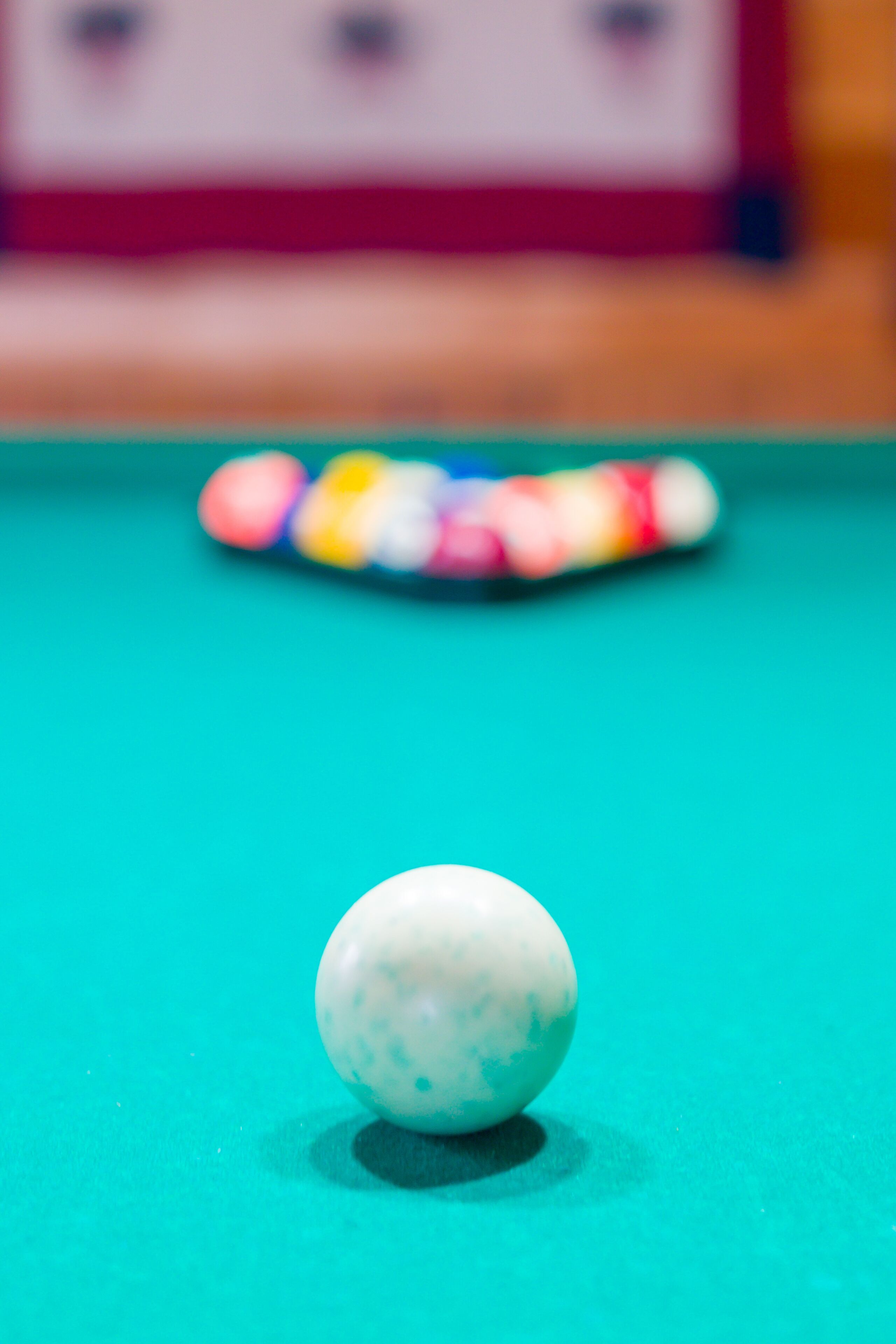 A close-up of a billiard ball on a pool table with a blurred background.