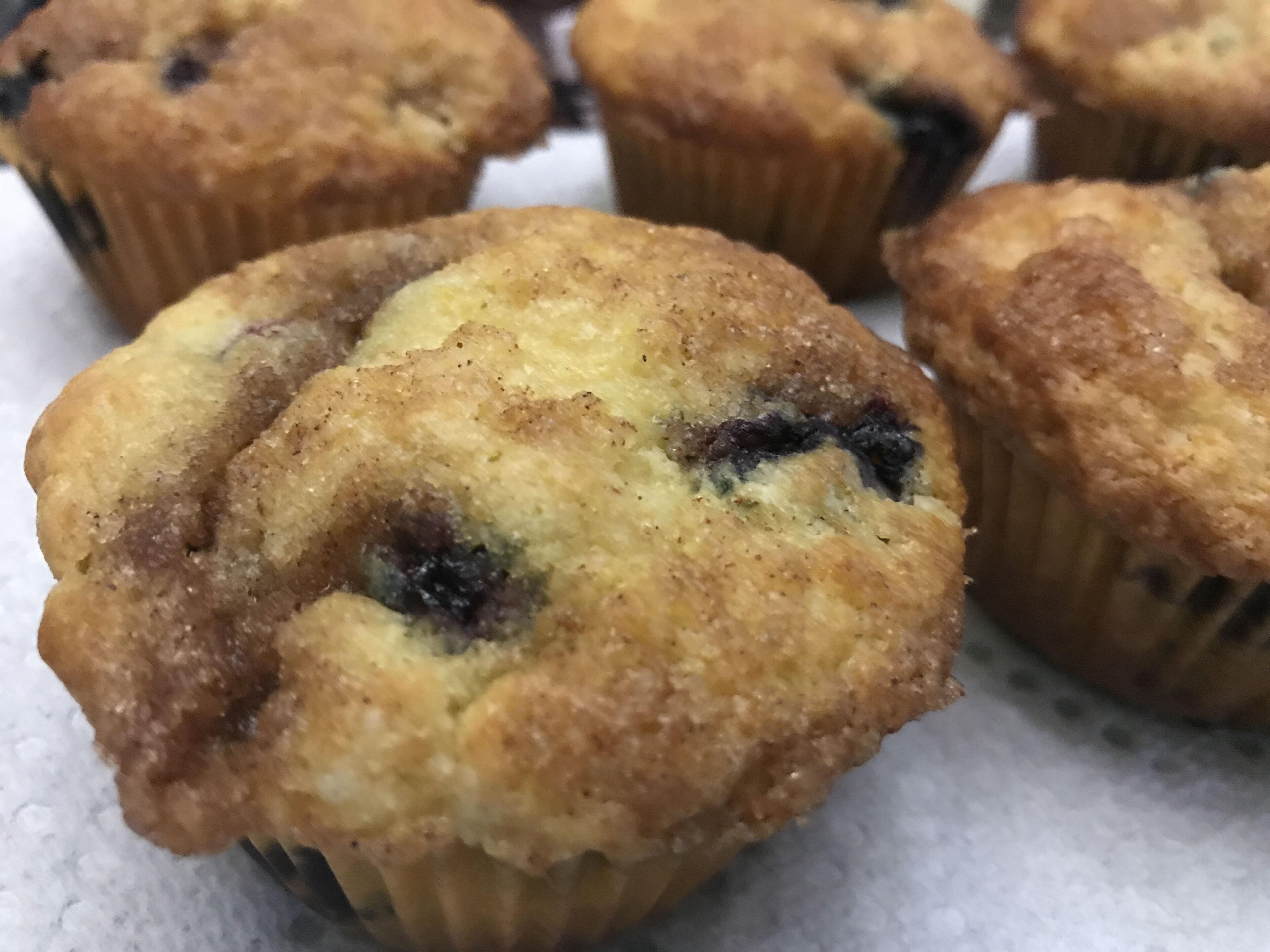 A close-up of freshly baked muffins with a golden-brown crust.