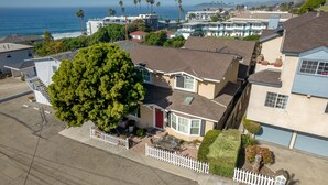 A residential area with houses, a white picket fence, and a large tree. - WALK to Beach, Pier and Downtown - Parking - BBQ - View (Pismo Beach)