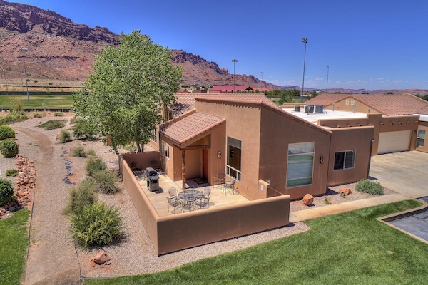 Large patio with Weber gas grill and outdoor furniture