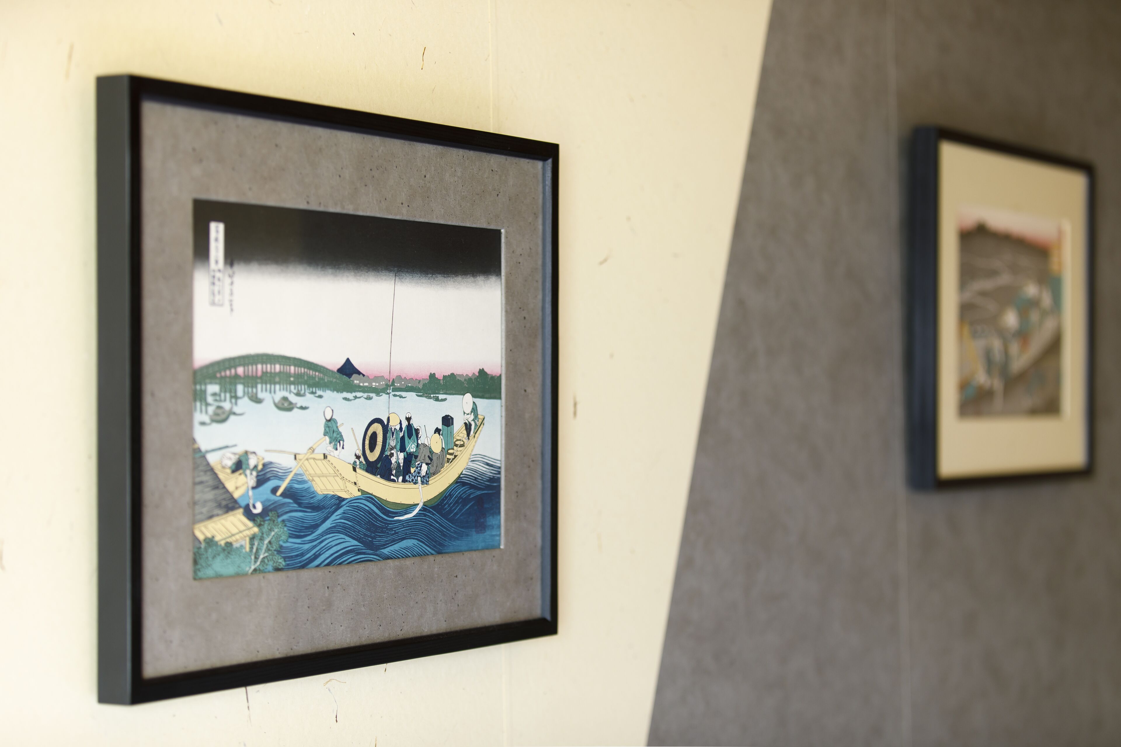 A framed artwork on a wall.