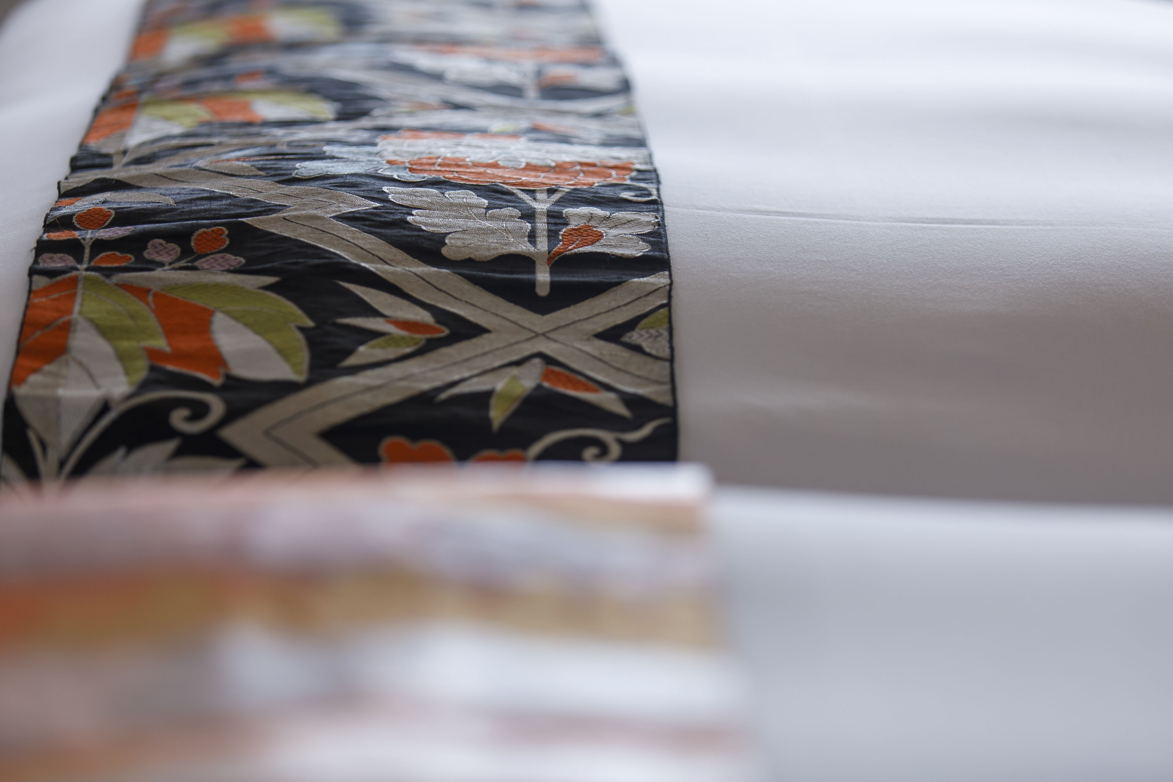 A close-up of a bed with a patterned bedspread.