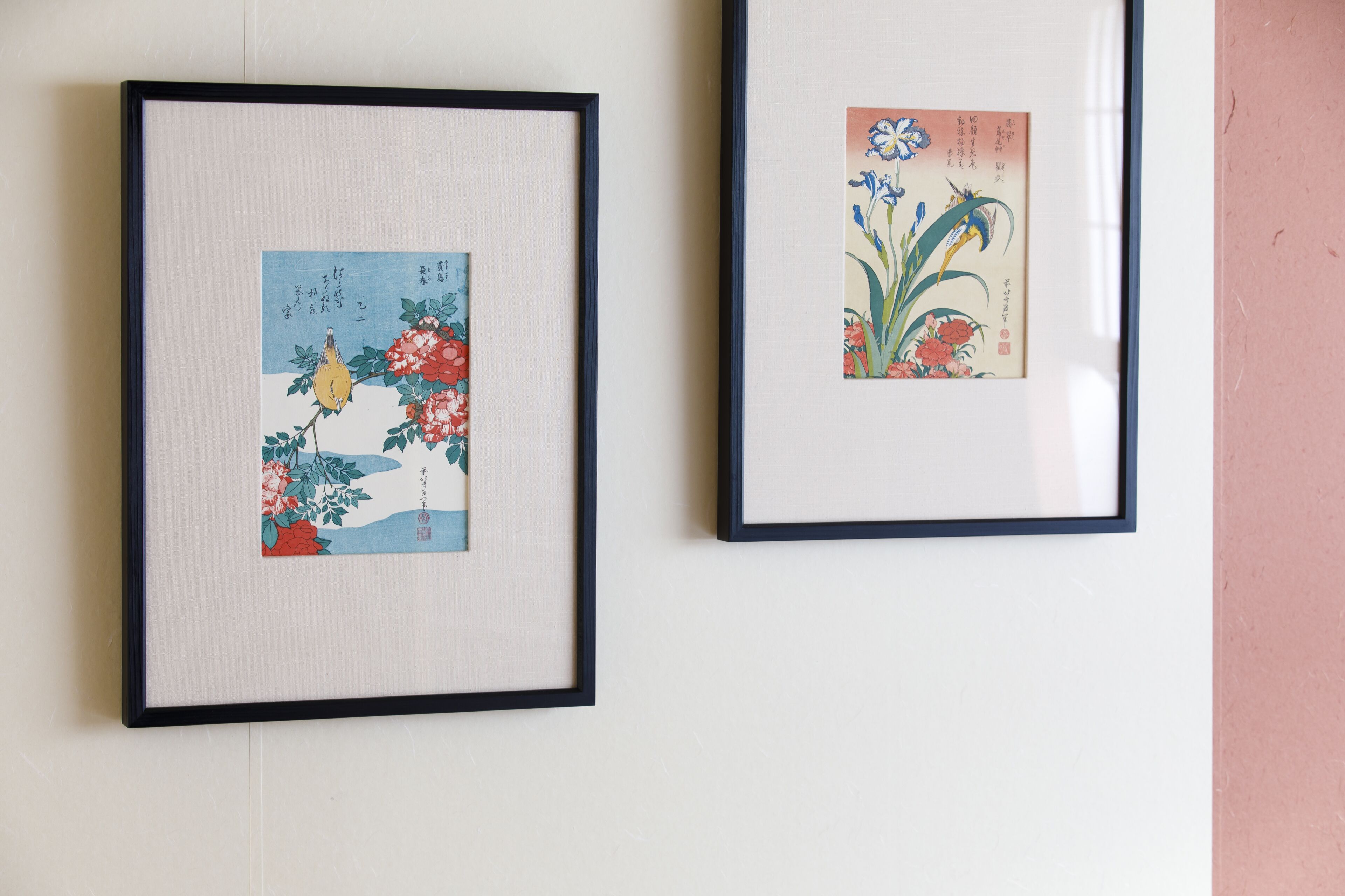Two framed artworks on a wall.