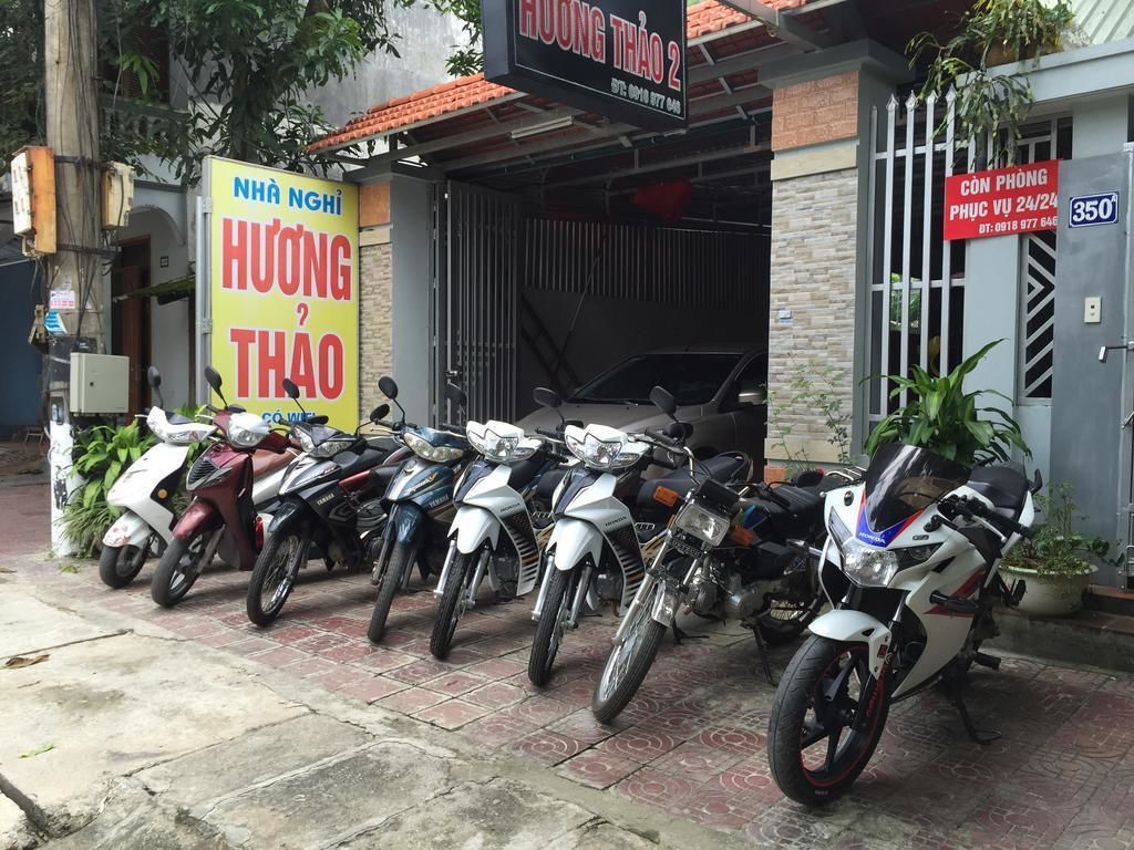 A motorcycle repair shop with several motorcycles parked outside.